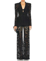 Black sequin outfit with a deep neckline and wide-leg pants on a white background