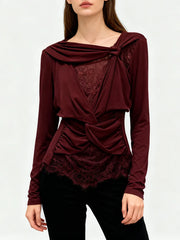 Model wearing draped lace detailed long sleeve top with irregular folds