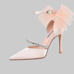 Delicate white lace pointed toe stiletto heel styled for a banquet event on a white background