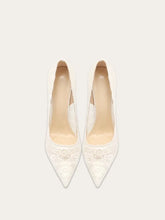 a lace pump with a pointed toe and a thin heel.