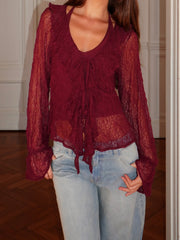 Detail view of the flared lace sleeves highlighting fabric transparency and movement.