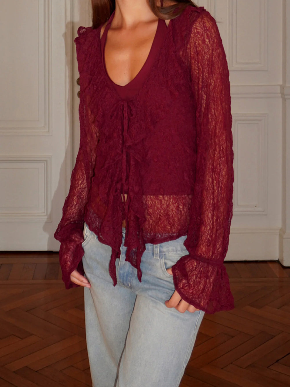 Lace long sleeve blouse styled casually with jeans for a relaxed, vintage-inspired look.