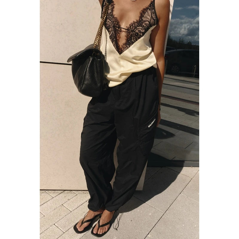 Detail shot highlighting the lace-trim hem and soft satin drape, showing the delicate edge finish and fluid texture.