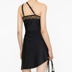 A close-up of the lace trim and fabric of the mini dress.