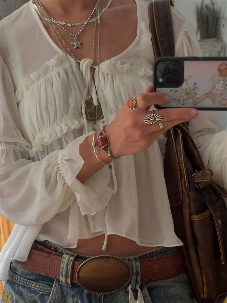 Close-up of lace tie detail and gathered bust on chiffon top