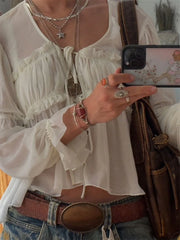 Close-up of lace tie detail and gathered bust on chiffon top