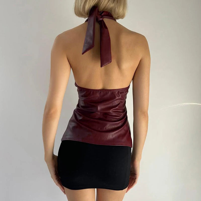 A full-length shot of a sexy backless vest styled for a night out.