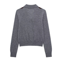 Patterned knit cardigan paired with relaxed trousers for weekday styling