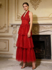 Tiered ankle-length party dress styled with heels against an ornate stone wall