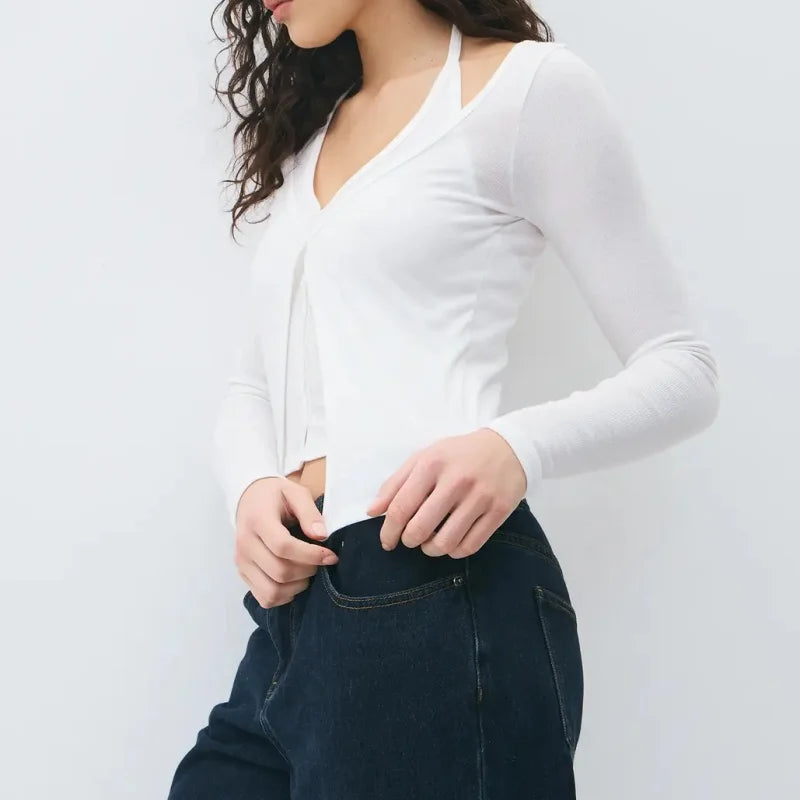 Layered knit long sleeve top styled casually with trousers for an understated everyday look.