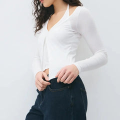 Layered knit long sleeve top styled casually with trousers for an understated everyday look.