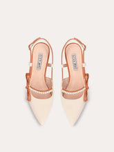 A pair of sandals with a thin heel, pearl beads, and a bow detail.