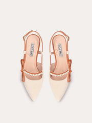 A pair of sandals with a thin heel, pearl beads, and a bow detail.