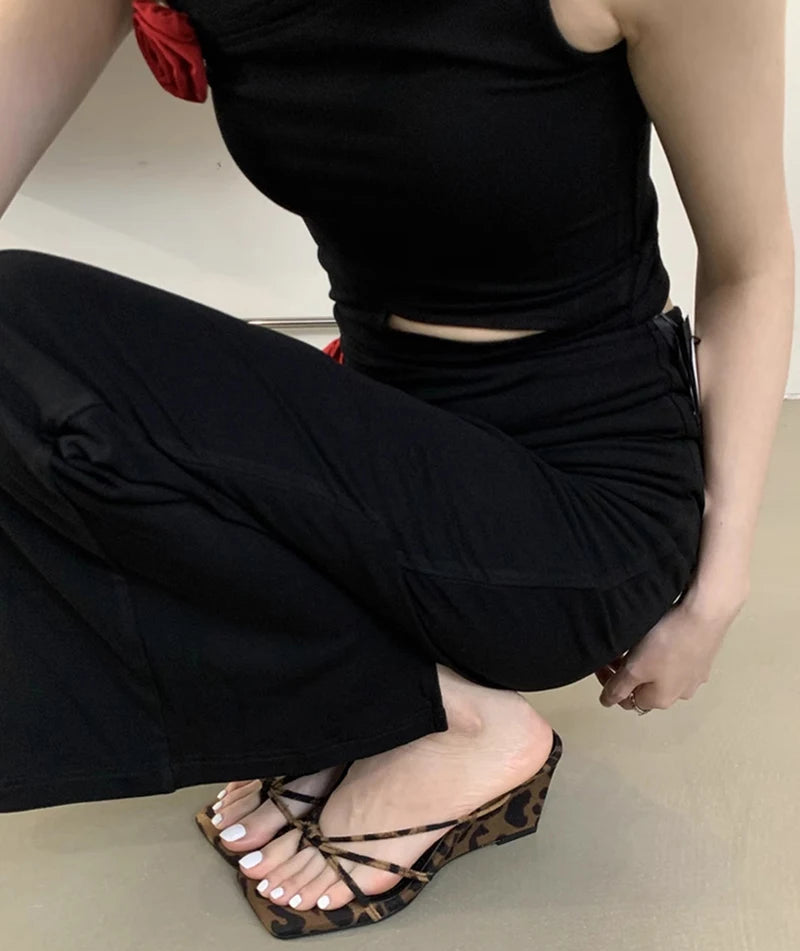 Leopard print wedge heel sandals with narrow straps worn indoors