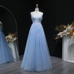 Full-length view of a backless A-line gown with airy tulle volume