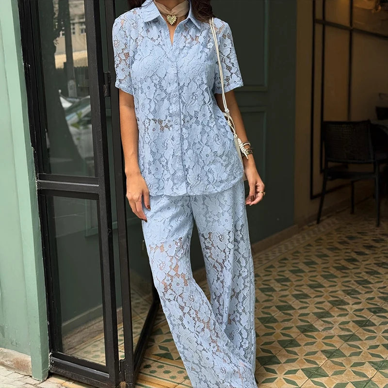 Button-front lace shirt and high-waist trousers set styled in a cafe setting