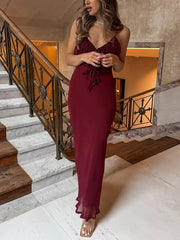 Lightweight burgundy slip dress shown on staircase for vacation vibe