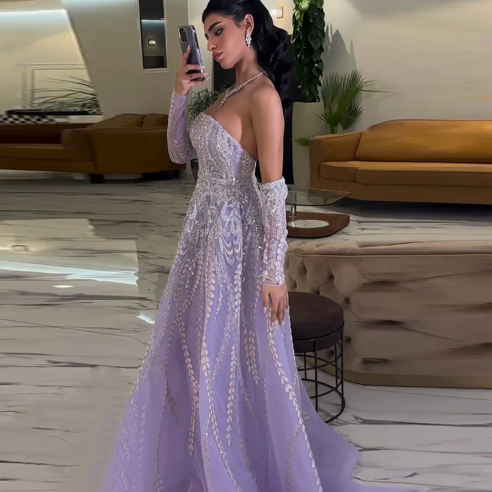 A woman wearing a lilac beaded A-line gown with cap sleeves for a formal event.