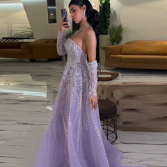 A woman wearing a lilac beaded A-line gown with cap sleeves for a formal event.