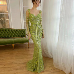 A woman wearing a lime green 3D floral mermaid gown with long sheer sleeves.