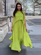 Woman wearing lime green pleated maxi dress on a city street