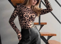 Person wearing a Bold one-piece leopard outfit for night events and black pants in an indoor setting