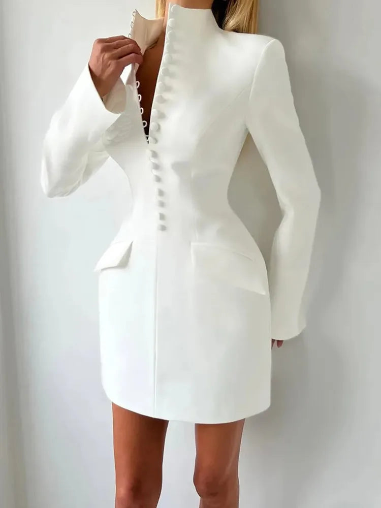 Full-length view highlighting the slim sheath fit and long sleeves of a blazer-inspired mini dress against a neutral background.