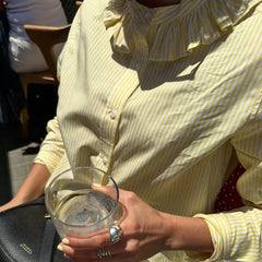 A full-length shot of a loose-fit blouse styled for a casual day out.