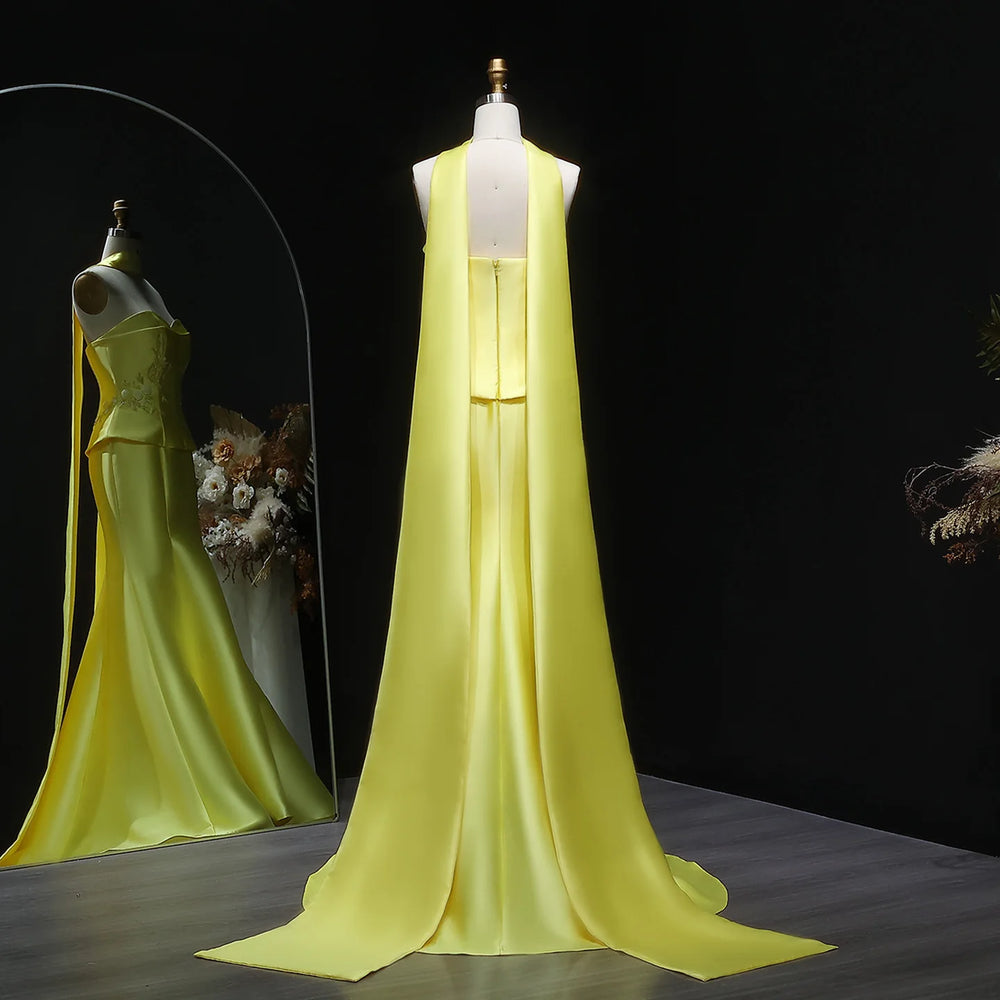 Yellow evening gown on a mannequin against a dark background