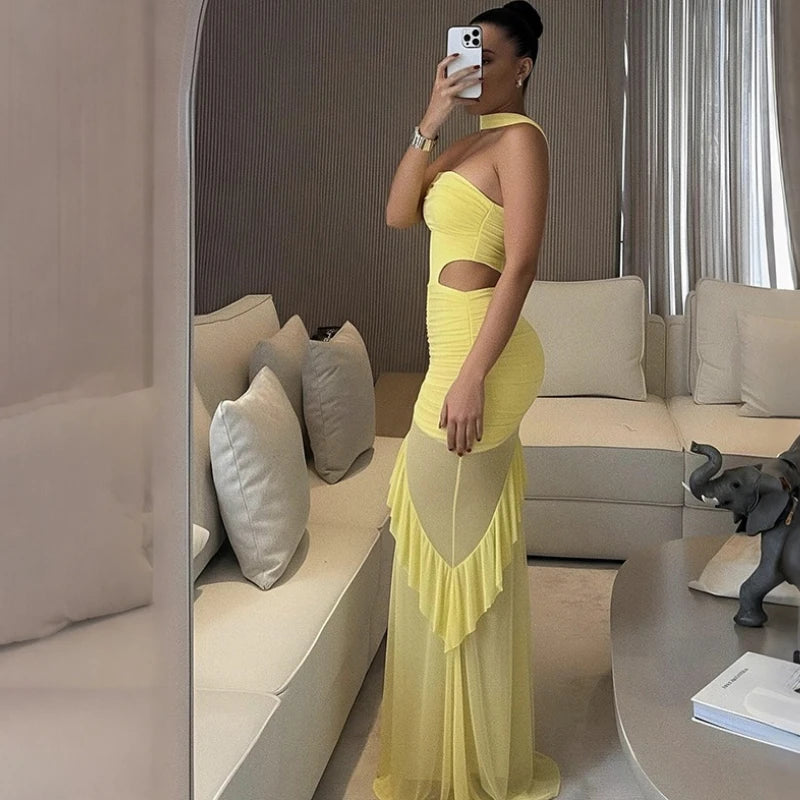 Side angle of a slim ruched maxi dress with sculpted waist shaping and flowing ankle-length mesh detail.