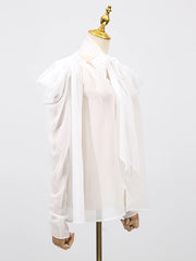 Tie-up sleeve blouse styled for an elegant setting, with fluid fabric movement and minimal accessories