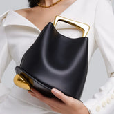 Irregular bucket bag with polished metal handle and smooth faux leather