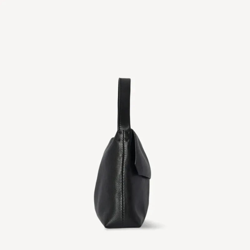 minimalist flap bag with single strap and structured finish