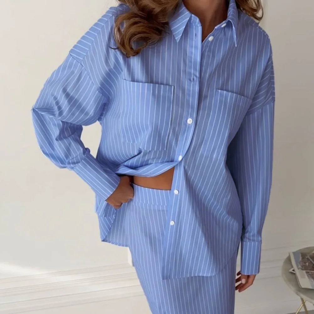 Person wearing a two-piece casual outfit with a button-up shirt and mid-skirt set against a plain background