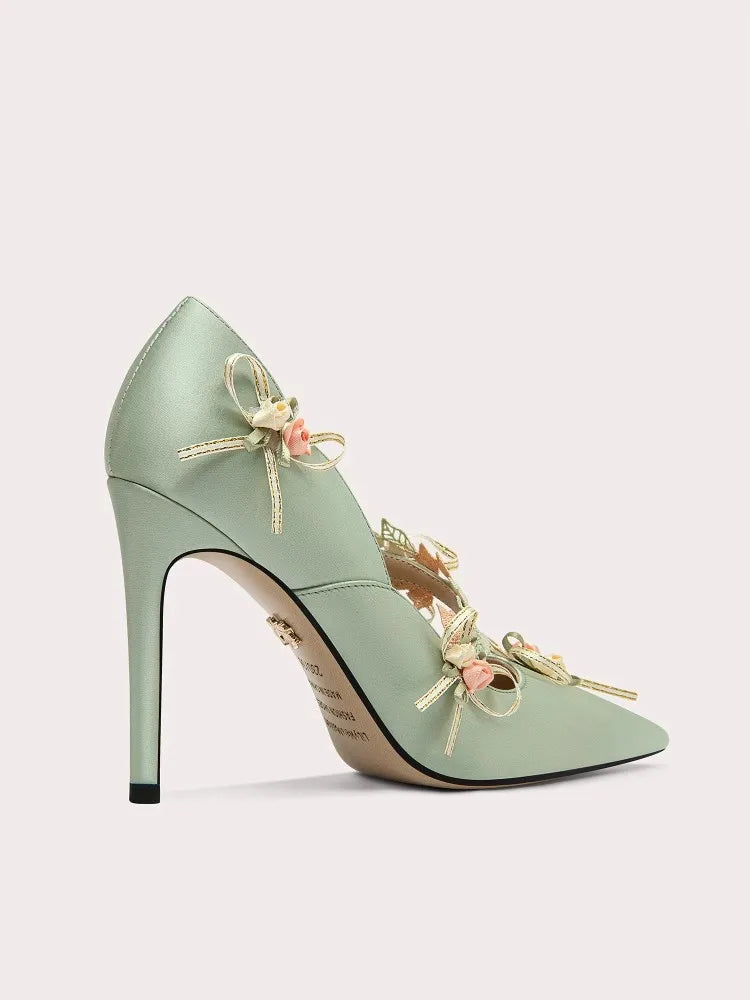 Mint-green-floral-bow-lace-stiletto-pump-spring on a light gray background