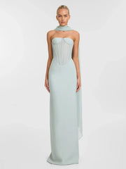 Woman wearing a mint strapless corset mesh patchwork gown with a scarf styled for formal events