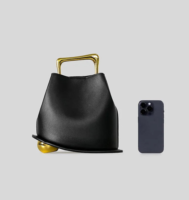 Sculptural bucket handbag with hasp closure and statement metal handle