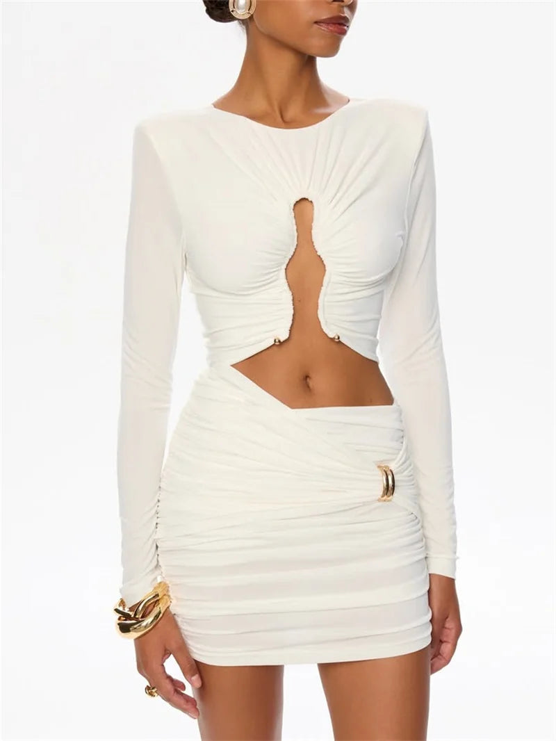 Styled evening look of a white cutout mini dress with sleek long sleeves, designed for polished dinner and party plans.