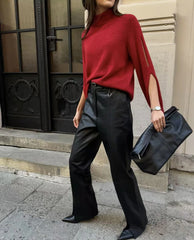 Styled look pairing the statement knit sweater with tailored bottoms for a winter outfit