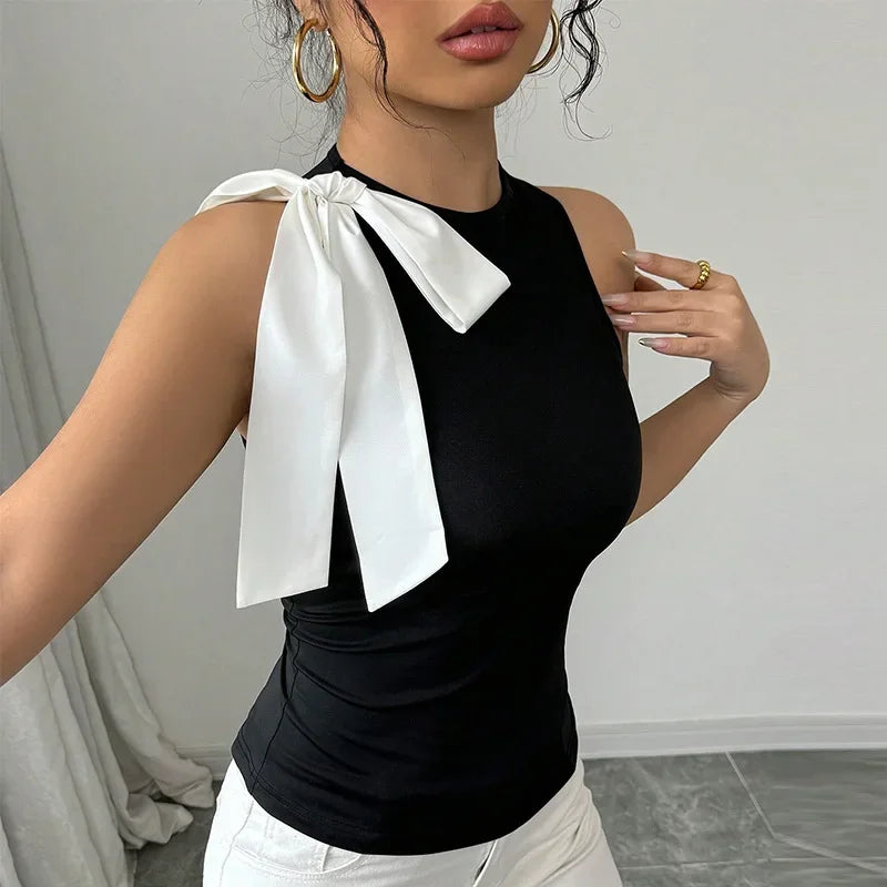 Monochrome sleeveless women’s top paired with white pants for brunch