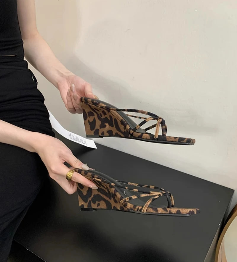 Stylish leopard print wedge sandals styled with black dress