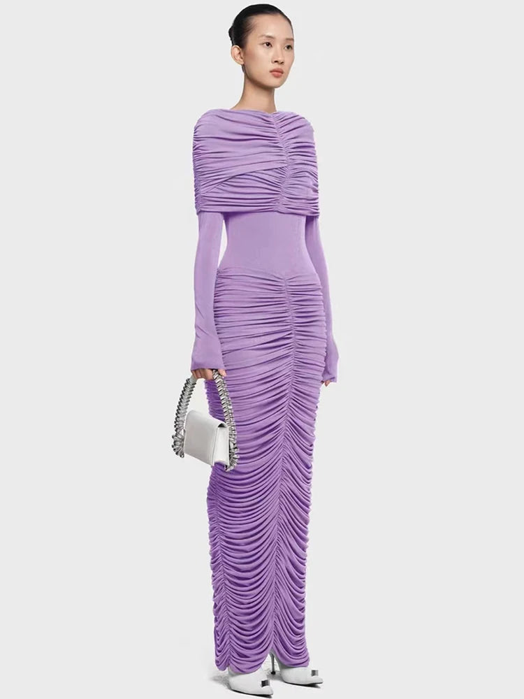 Full-length view of a pleated formal dress with slim silhouette on a plain background