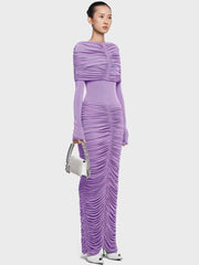 Full-length view of a pleated formal dress with slim silhouette on a plain background