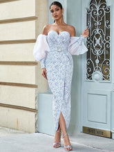 A woman modeling a light blue off-shoulder jacquard gown with a sweetheart neckline.