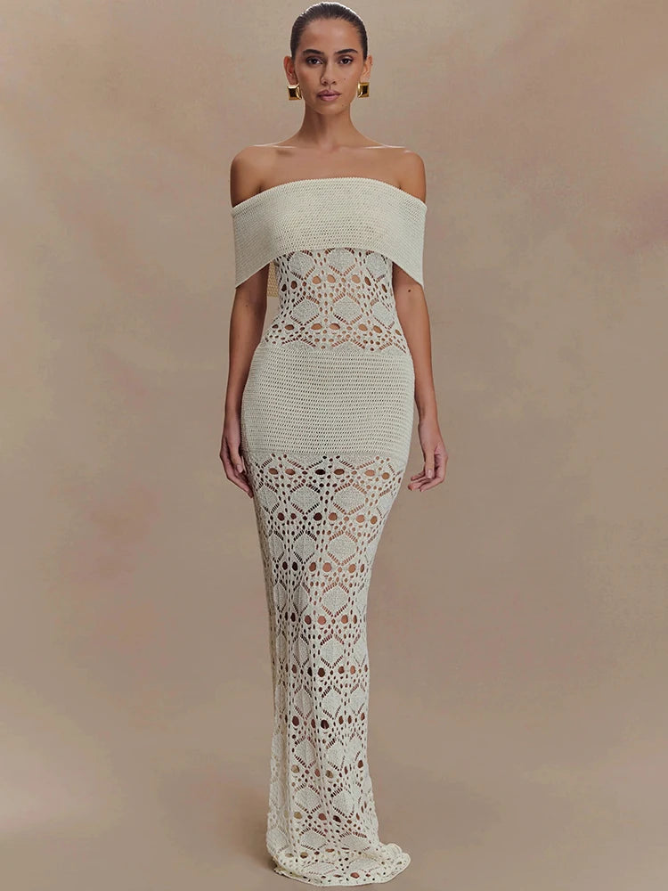 Woman wearing a white off-shoulder knit maxi dress with hollow-out texture on a beige background