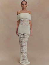 Woman wearing a white off-shoulder knit maxi dress with hollow-out texture on a beige background