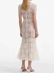 A full-length shot of an elegant dress, styled for a day at the office.