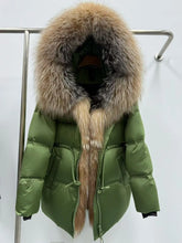 Olive hooded down puffer jacket hanging on a rack, framed by an oversized natural fur trim that drapes down the front.