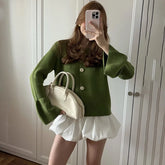 Olive green knit cardigan styled for modern autumn layering