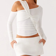 A woman modeling a one-shoulder long-sleeve slim-fit top.